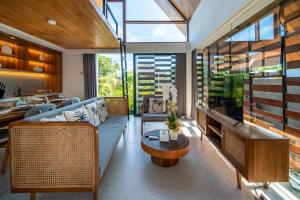 a living room with a blue couch and a table at Villa Amiti - Luxurious Haven Loft in Ricefields in Ubud