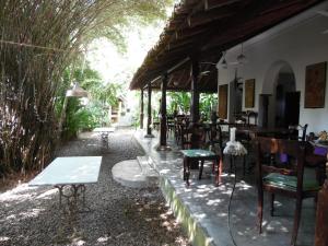 a restaurant with tables and chairs on a patio at The Dream House in Unawatuna