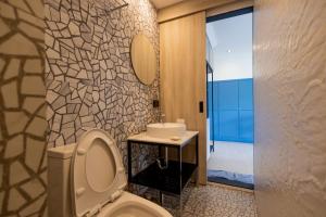 a bathroom with a toilet and a sink at Penpark Place in Bangkok