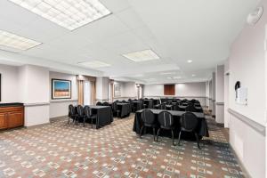 a conference room with tables and chairs and a podium at Hampton Inn Pennsville in Pennsville