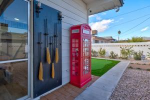 a red phone booth sitting outside of a house at A Wizards Stay Hogwarts Way in Las Vegas
