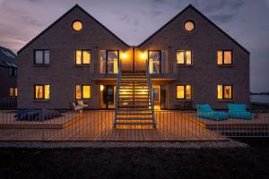a house with a staircase in front of it at Apartments Rooftop Garden 1 - 4 im Ostseeresort Olpenitz in Olpenitz +29 photos