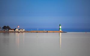 a lighthouse in the middle of a body of water at Apartments Rooftop Garden 1 - 4 im Ostseeresort Olpenitz in Olpenitz