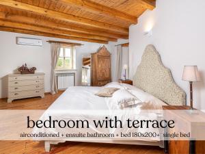 a bedroom with a bed with a wooden ceiling at Villa Paolina with hot tub in Višnjan