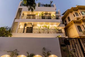 a large white building with lights on it at Wanderlust A Boutique Homestay in Udaipur
