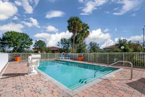 a swimming pool in front of a fence at Comfort Inn & Suites Tavares North in Tavares