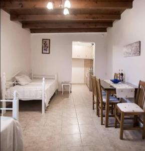 a bedroom with a bed and a table and chairs at Elleana south Corfu in Agios Georgios +169 photos