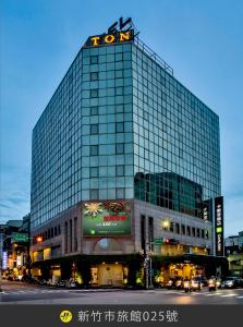 a tall building with a sign on top of it at The Carlton Hotel Hsinchu in Hsinchu City