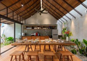 a large dining room with a large wooden table and chairs at AN Village 1 in Vung Tau