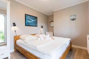 a bedroom with a large bed with white sheets at Tante Schmidt 1 in Staberdorf