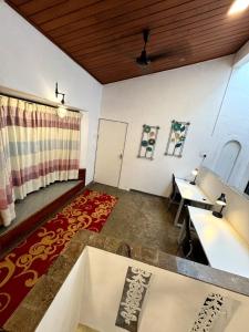 a living room with a table and a desk at Eden villa colombo in Kirillapone
