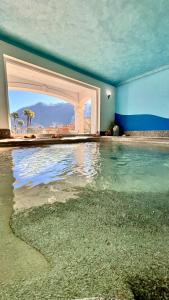 a room with a pool of water with an open door at Yachting Residence in Lavena Ponte Tresa