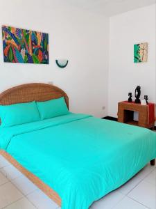 Un dormitorio con una cama grande con sábanas azules. en Happy Home Hotel Beachfront, en Boracay