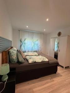 a bedroom with a large bed in a room at Ferienwohnung Mobembo in Konz +13 photos