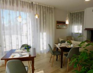 a living room with a table and chairs and a couch at b&b Tati in Sedico