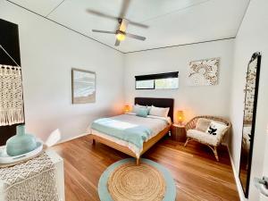 a bedroom with a bed and a ceiling fan at Panda's Patch Dunsborough in Dunsborough
