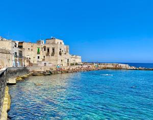 a large body of water next to a castle at Dimora nel Palazzo Ducale with private parking in Giovinazzo