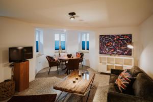 a living room with a couch and a table at Appartements EICHENHOF in Bad Salzuflen