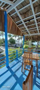 a wooden table and a wooden chair on a porch at Niro House and Restaurant in Ahangama