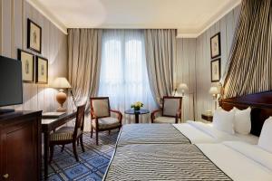 a hotel room with a bed and a desk at Le Dokhan's Paris Arc de Triomphe, a Tribute Portfolio Hotel in Paris