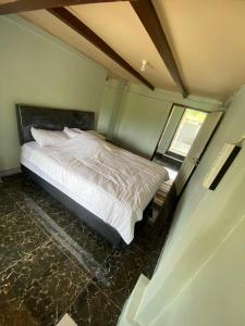 a bedroom with a white bed in a room at Lokon Vila and Camp in Tomohon