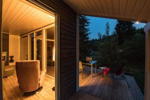 a screened in porch with a chair and a table at 4 Personen mit Sauna F2H3 in Ruhla