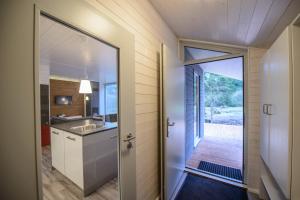 a bathroom with a sink and a door to a kitchen at 4 Personen mit Sauna F0H8 in Ruhla