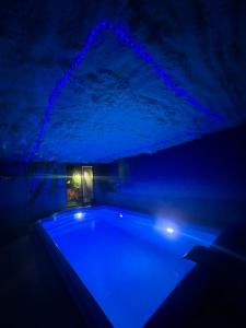 ciemny pokój z wanną z niebieskimi światłami w obiekcie APARTAMENT Solny SPA w mieście Rzeszów