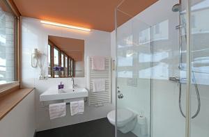 a bathroom with a shower and a sink and a toilet at Haus Marlene in Schoppernau +27 photos