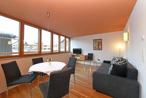 a living room with a table and chairs at Haus Marlene in Schoppernau