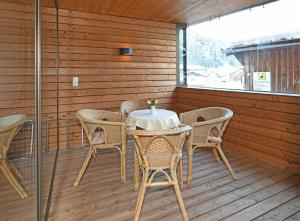 a patio with a table and chairs on a deck at Haus Marlene in Schoppernau