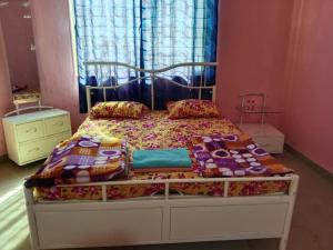 a bedroom with a bed with a bed frame at Dev anand Villa in Mahabaleshwar