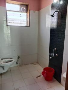 a bathroom with a shower and a toilet and a sink at Dev anand Villa in Mahabaleshwar