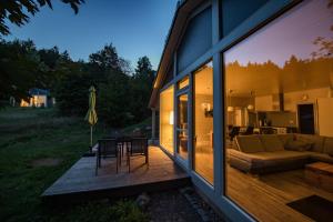 a house with a deck with a couch and a table at 4 Personen mit Sauna F0H3 in Ruhla +16 photos