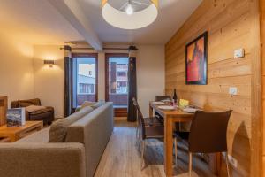 瓦洛西讷l'Ours Bleu B01 - Ski in Ski out - Happy Rentals的客厅里有一张沙发和一张桌子。