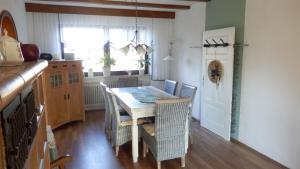 a kitchen with a table and chairs and a window at Ferienwohnung Margit in Sulzfeld