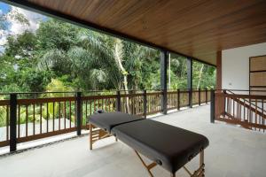 a treadmill on a balcony with a view of trees at Villa So Hum by BaliSuperHost in Ubud