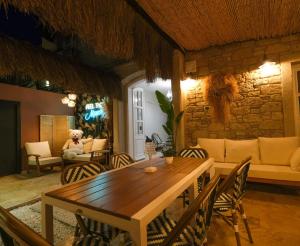a dining room with a wooden table and chairs at DBD Alaçatı in Alaçatı