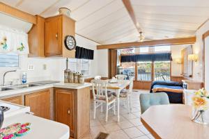 a kitchen and dining room with a table and chairs at Lakefront Retreat in Badin Shores Resort home in New London