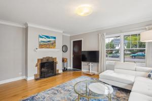 a living room with a white couch and a fireplace at The McKinley House condo in Eau Claire