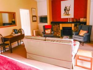 a living room with a couch and a fireplace at Watersmeet cottages in Dullstroom