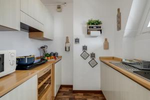 a kitchen with white walls and a counter top at Studio Blue Petit - Happy Rentals in Sestriere