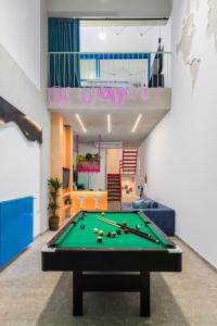 a living room with a pool table in a room at Fabrica PlayLoft in the City Center by BiNoBi! in Thessaloniki