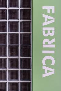 a row of clear glass windows with a sign on it at Fabrica PlayLoft in the City Center by BiNoBi! in Thessaloniki