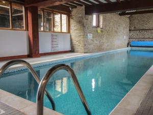 a swimming pool with blue water in a building at Walton Maisonette in Craven Arms