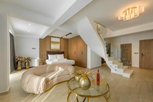 a living room with a bed and a glass table at Platinum Suites in Ioannina