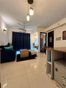 a living room with a couch and a table at Blueberry- Aashray in Noida +22 photos