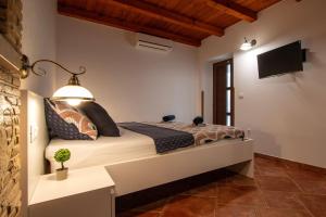 a bedroom with a bed and a tv on the wall at Studio Mateo in Rovinjsko Selo +10 photos