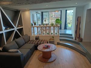 a living room with a couch and a table at Loft avec Sauna et Jacuzzi in Solliès-Pont +2 photos