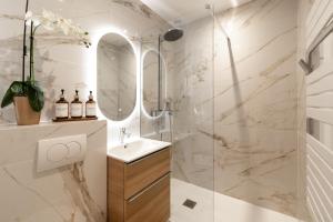 a bathroom with a sink and a shower at Luxury Suite Monaco SeaView Terrace and Pool in Beausoleil